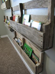 two wooden shelves with books on them in a hallway next to a carpeted floor