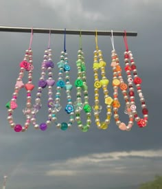 several beads hanging from a clothes line on a cloudy day