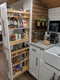 a kitchen with white cabinets and wooden shelves