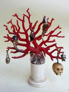 there is a red coral with skulls and other items in the shape of a tree