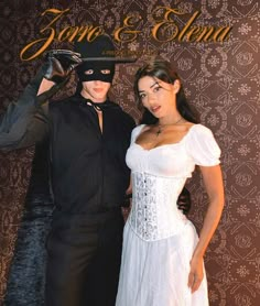 a man and woman dressed up in costume posing for a photo with a mask on