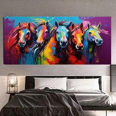 three horses painted on a wall above a bed