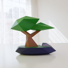 an abstract tree sculpture sitting on top of a table