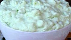 a white bowl filled with food on top of a table