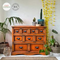 an orange dresser with many drawers and plants