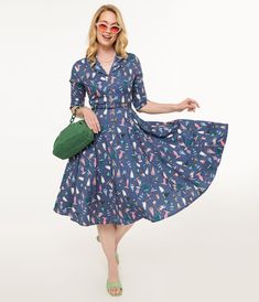 This delightful 1940s dress features a charming ski print that captures the magic of snowy adventures, while its flattering fit and flare silhouette will have you twirling through any holiday gathering. The vintage-inspired wooden buttons add a unique touch, complemented by three-quarter length sleeves for that perfect blend of style and warmth. With handy side pockets to hold your essentials, this dress is both functional and fabulous..Available in sizes XS-4X while supplies last. | Royal Monk 1940S Blue Ski Snow Season Fit & Flare Dress | Size Small Snow Season, Ski Print, Dress Unique, 1940s Dresses, Wooden Buttons, Holiday Gathering, Fit Flare Dress, Fit & Flare