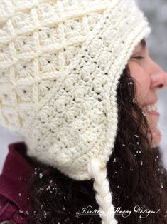 a woman wearing a white crocheted hat in the snow