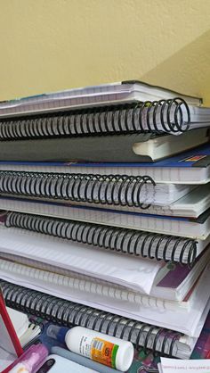 a stack of notebooks sitting on top of a desk