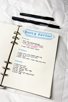 a notebook with daily routine written on it