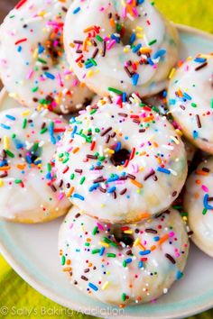 there are many donuts with sprinkles on the plate