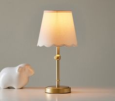 an elephant lamp sitting next to a small white bear figurine on a table