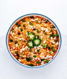 an overhead view of a bowl of mexican food with cheese and jalapenos