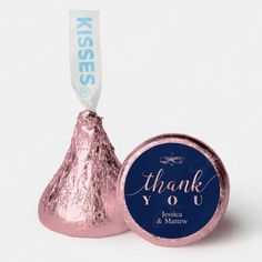 a blue and white thank you sticker next to a pink hershey