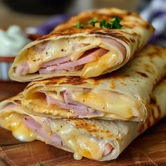 two quesadillas stacked on top of each other with cheese and meat in the middle