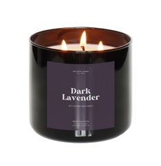 a black candle with three lit candles in it and the words dark lavender on top