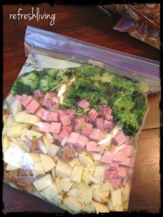 a bag filled with potatoes and broccoli on top of a wooden table