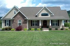 a house in the middle of a grassy field