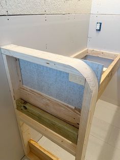 a wooden bench sitting on top of a white tiled floor