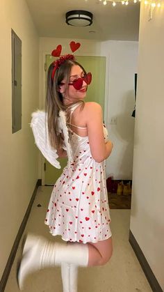 a woman in a white dress and red heart glasses