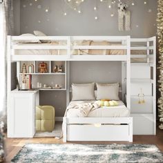 a white bunk bed sitting in a bedroom next to a desk and christmas lights on the wall