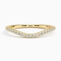 a yellow gold wedding band with diamonds on the sides and a curved design in the middle