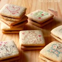 several decorated cookies sitting on top of a wooden table