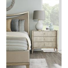 a bedroom scene with focus on the bed and nightstand