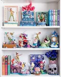 the shelves are filled with figurines, books and other decorative items on them