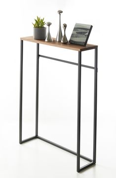 a wooden table with metal legs and a laptop on it's top, in front of a white background