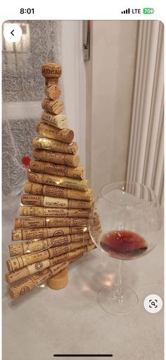 a wine glass sitting next to a cork christmas tree