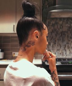 a woman with tattoos on her neck is looking at something in the distance and has an instagram