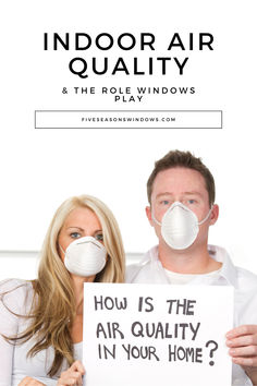 a man and woman holding a sign that says how is the air quality in your home?