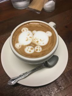 a cappuccino with some white teddy bears on it