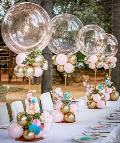 a table topped with lots of balloons and flowers