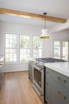 a kitchen with an oven, stove and counter top in the middle of the room