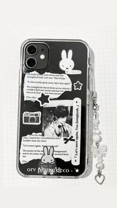 an iphone case with some stickers on it and a keychain attached to the back