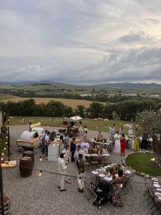 a group of people standing around tables and chairs