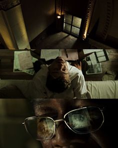 a man in glasses is laying down on the bed and looking up at his reflection