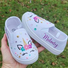 "Just as shown but with your child's name on the sides in purple. Everything about these shoes is sparkly and glittery. My designs and bling stays put! She will love these and you will too!  To visit my entire etsy shop and see all 200 of my items, please click here: cloversaigestudio.etsy.com Shoe measurements from heel to toe on soles of shoes: 5/6= 6\" 7/8= 6 3/4\" 9/10= 7\" 11/12= 7 3/4\"" Dyi Decoupage Shoes, Unicorn Birthday Shoes, Name Slip, Canvas Shoes Diy, Monogram Shoes, Unicorn Shoes, Bedazzled Shoes, Painted Shoes Diy, Painted Canvas Shoes