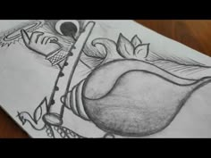 a pencil drawing of an apple with leaves on it and a spoon in the middle