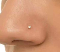 a woman's breast with a single diamond on it