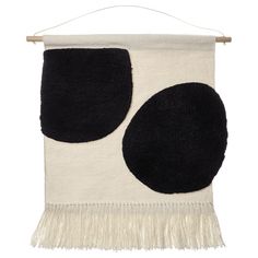 a black and white wall hanging with two circles