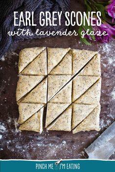 some crackers are cut into squares and sitting on a table with flowers in the background