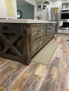 a kitchen with wood flooring and an island made out of old barn door doors