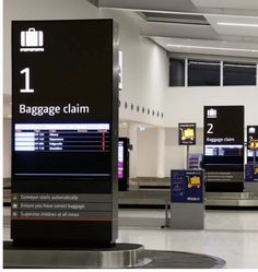 the baggage claim area at an airport with luggage bags on them and signs showing where to go