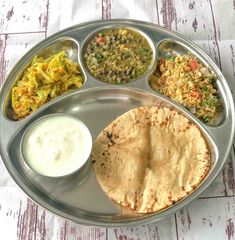 a metal plate topped with different types of food