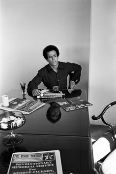 a man sitting at a desk with some books