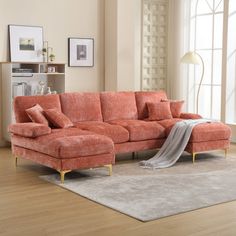 a living room with an orange couch and rug