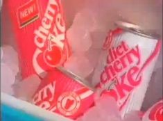 two cans of diet coke sitting on top of each other in an ice cube container