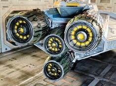 an image of a sci - fi vehicle with yellow wheels